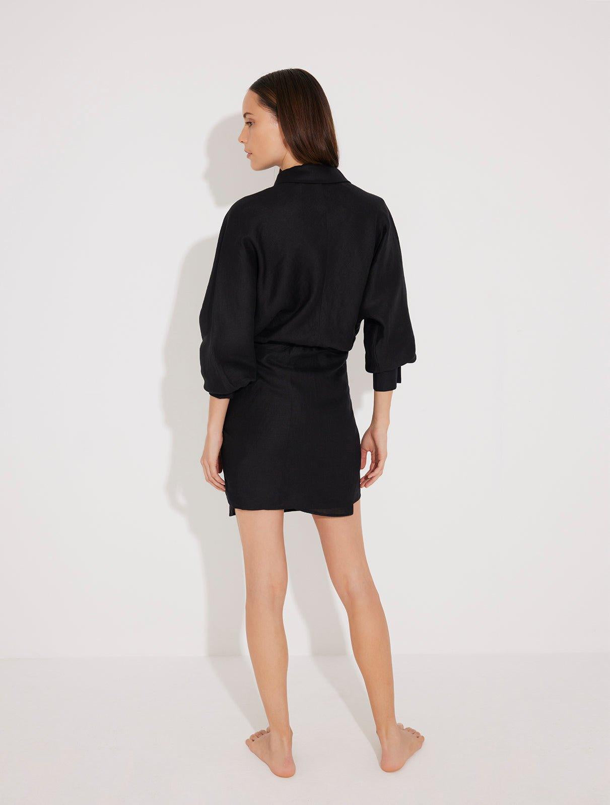 "Back view of the Guadalupe Dress on a model, illustrating the tie-back detail and flowy silhouette."
