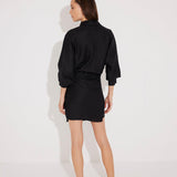 "Back view of the Guadalupe Dress on a model, illustrating the tie-back detail and flowy silhouette."
