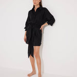 "Front view of a model in the Guadalupe Black Dress, showcasing its cinched waist and elegant silhouette."