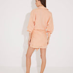 "Back view of the Guadalupe Dress on a model, illustrating the tie-back detail and flowy silhouette."