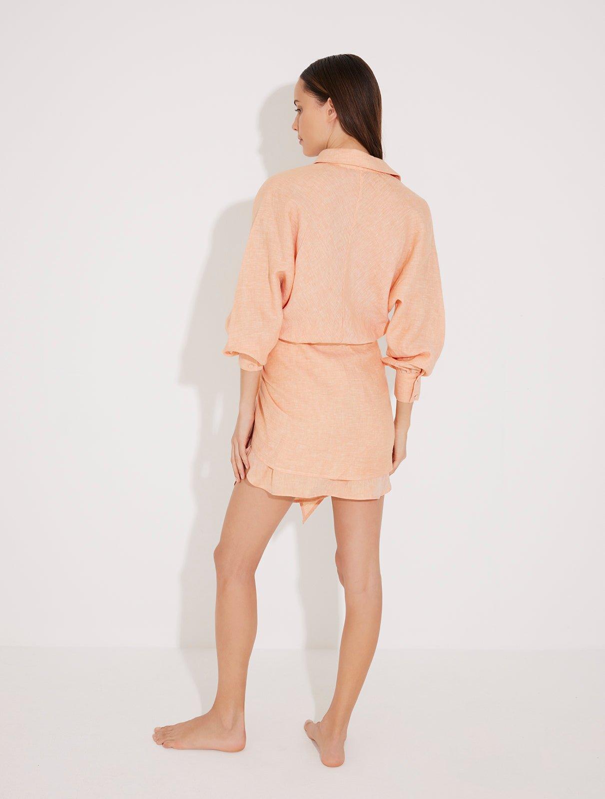 "Back view of the Guadalupe Dress on a model, illustrating the tie-back detail and flowy silhouette."