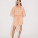 "Front view of a model in the Guadalupe Orange Dress, showcasing its cinched waist and elegant silhouette."