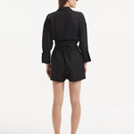 "Model wearing the Masha Black Shorts from the back, emphasizing the high-waisted cut and the relaxed, loose fit."