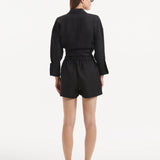 "Model wearing the Masha Black Shorts from the back, emphasizing the high-waisted cut and the relaxed, loose fit."
