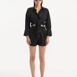 "Model wearing the Masha Black Shorts from the front, showcasing the high-waisted design and loose fit."