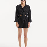 "Model wearing the Masha Black Shorts from the front, showcasing the high-waisted design and loose fit."