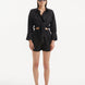 "Model wearing the Masha Black Shorts from the front, showcasing the high-waisted design and loose fit."