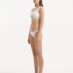 Side view of Harbor White Bikini Set, featuring the one-shoulder top and mesh details on the bikini bottoms.