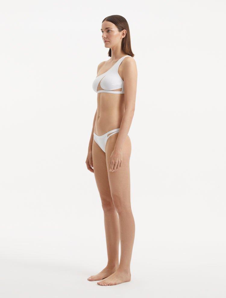 Side view of Harbor White Bikini Set, featuring the one-shoulder top and mesh details on the bikini bottoms.