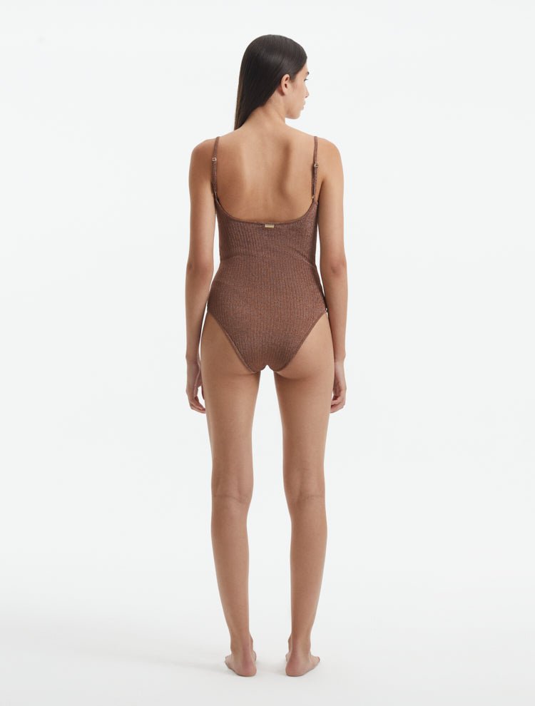 Back View: Model in Hartley Brown Swimsuit - Fully Lined, Metallic, Moderate Bottom Coverage, One Piece Swimsuit,  MOEVA Luxury Swimwear 