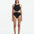Front View: Model in Honora Black Swimsuit - MOEVA Luxury Swimwear, Cut Out Silhouette, Two Halves Held Together By Accessory, Crushed Round Gold Accessory, High Neckline, MOEVA Luxury Swimwear 