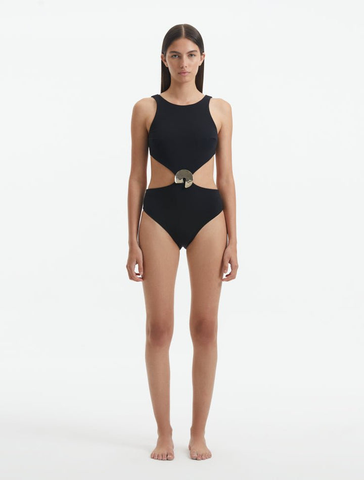 Front View: Model in Honora Black Swimsuit - MOEVA Luxury Swimwear, Cut Out Silhouette, Two Halves Held Together By Accessory, Crushed Round Gold Accessory, High Neckline, MOEVA Luxury Swimwear 