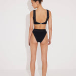 Back View: Model in Ilari Black Bikini Bottom - High-Waisted Swim Bottom, Moderate Bottom Coverage, Lined, Italian Fabric, Special Lycra Xtralife Certificate, MOEVA Luxury Swimwear  