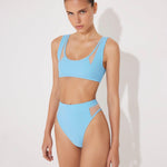Front View: Model in Ilari Blue Bikini Bottom - MOEVA Luxury Swimwear, Comfort and Sportive, High-Waist, High-Leg Silhouette, Mesh Details, Multicolor Option, MOEVA Luxury Swimwear  