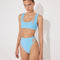 Front View: Model in Ilari Blue Bikini Bottom - MOEVA Luxury Swimwear, Comfort and Sportive, High-Waist, High-Leg Silhouette, Mesh Details, Multicolor Option, MOEVA Luxury Swimwear  