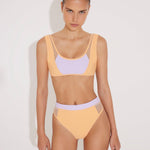 Front View: Model in Ilari Orange/Lilac Bikini Bottom - MOEVA Luxury Swimwear, Comfort and Sportive, High-Waist, High-Leg Silhouette, Mesh Details, Multicolor Option, MOEVA Luxury Swimwear  