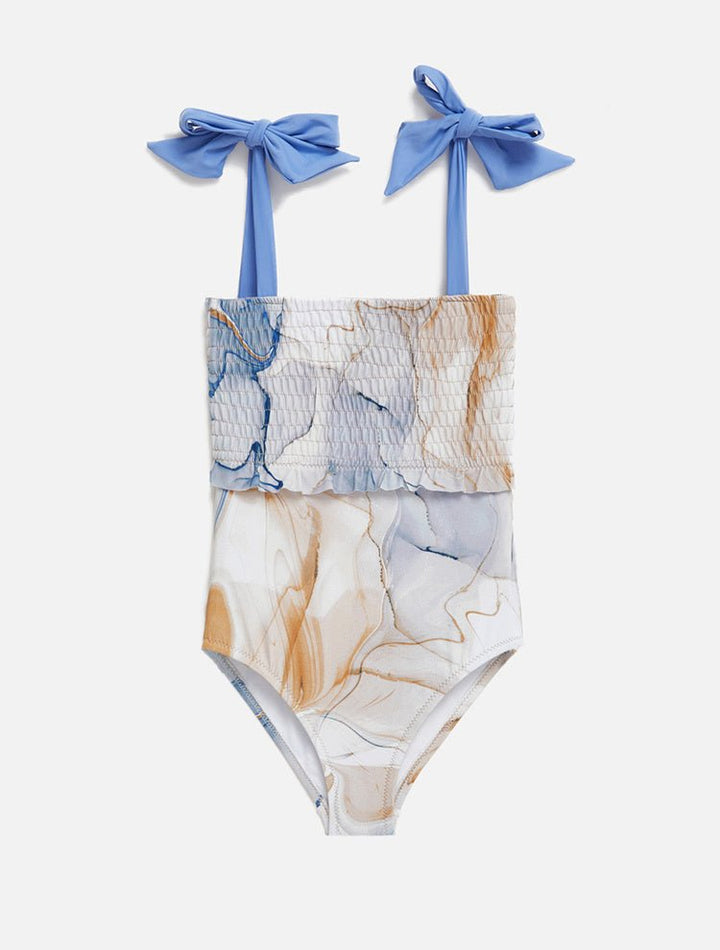 Front View: Ilaria Blue Abstract Kids Swimsuit - One Piece, Shirred Bodice, Satin Self-Tie Straps, Ruffle Details, Full Bottom Coverage, MOEVA Luxury Swimwear