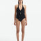 Front View of Model Wearing Imelda Black Swimsuit - MOEVA Luxury Swimwear, Halter Neck, Tie Neck, V Neckline, Draped Front Piece Detail, Removable Padding One Piece Women's Swimwear, Twisted Gold Accessory, MOEVA Luxury Swimwear   