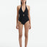 Front View of Model Wearing Imelda Black Swimsuit - MOEVA Luxury Swimwear, Halter Neck, Tie Neck, V Neckline, Draped Front Piece Detail, Removable Padding One Piece Women's Swimwear, Twisted Gold Accessory, MOEVA Luxury Swimwear   