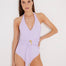 "Model wearing the Imelda Lilac Swimsuit from the front, showcasing the halter neck design and gold wave accessory."