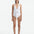 Front View of Model Wearing Imelda Imelda White Swimsuit - MOEVA Luxury Swimwear, Halter Neck, Tie Neck, V Neckline, Draped Front Piece Detail, Removable Padding One Piece Women's Swimwear, Twisted Gold Accessory, MOEVA Luxury Swimwear   
