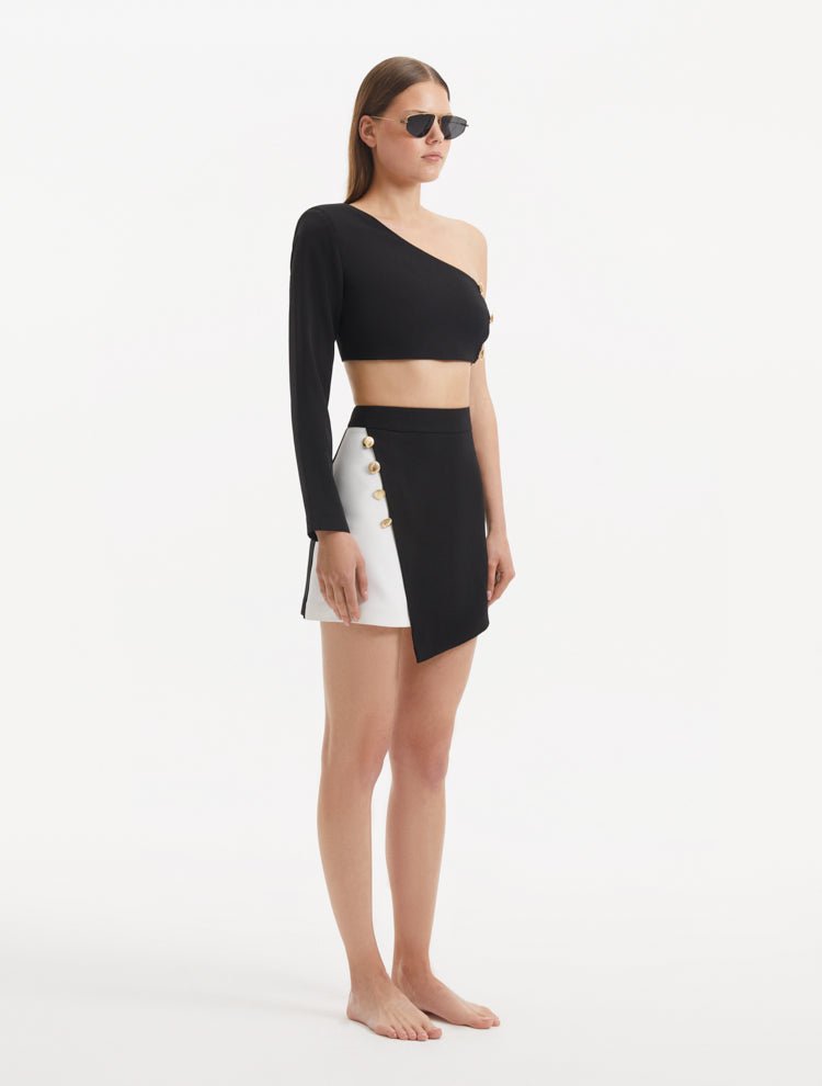 "India black/white skort from the back, revealing its clean lines and high-rise waist that accentuates the silhouette. "