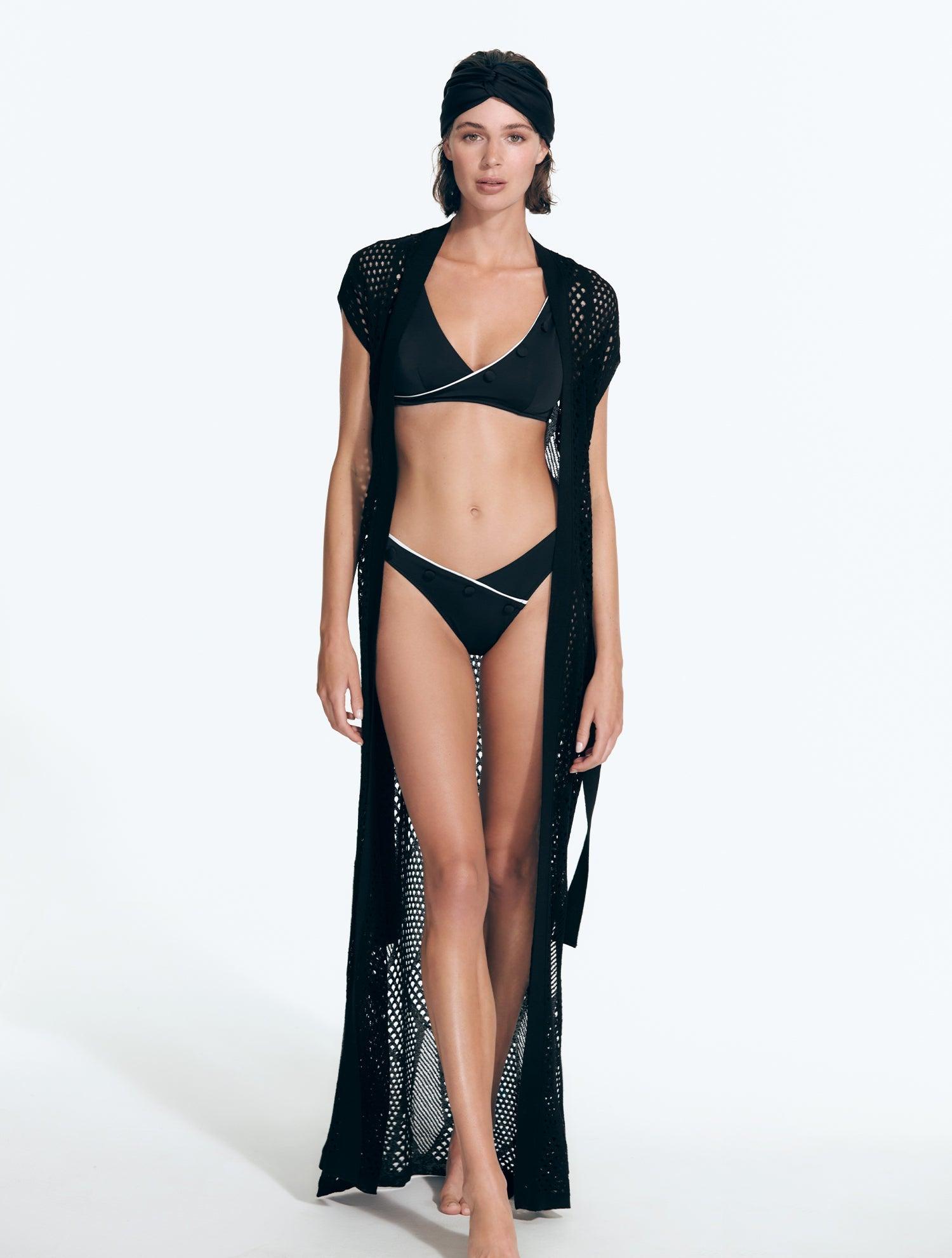 "Front view of the Ines Black Kaftan, showcasing its sheer fabric, elegant knit pattern on the sleeves, and self-tie belt."