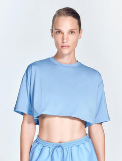 "Isolde Blue Cropped Top front view featuring a loose fit and short sleeves. The cropped design provides a relaxed and stylish look, ideal for various workouts and casual activities."