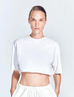 "Isolde White Cropped Top front view showcasing a loose fit and short sleeves. The top's white color and cropped style make it a versatile and trendy choice for various workouts and casual wear."