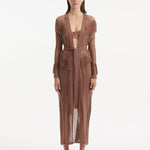 "Model wearing the Itzel brown kaftan from the front, showcasing its hand-knit design, earthy brown color, and fringed details, paired with vibrant swimwear."