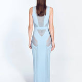 "Back view of the Izzy Baby Blue Dress highlighting its ankle-length silhouette, sleeveless top, and semi-sheer knit fabric with intricate stripe details."