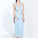 "Front view of the Izzy Baby Blue Dress showing its elegant ankle-length cut, sleeveless design, and V-neckline, with detailed semi-sheer knit patterns and stripes."