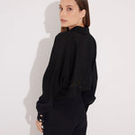 Back View: Model in Jacinta Black Shirt - MOEVA Luxury Swimwear, Gold Button Detail Throughout, Recycled and Textured Fabric, MOEVA Luxury Swimwear