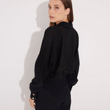 Back View: Model in Jacinta Black Shirt - MOEVA Luxury Swimwear, Gold Button Detail Throughout, Recycled and Textured Fabric, MOEVA Luxury Swimwear