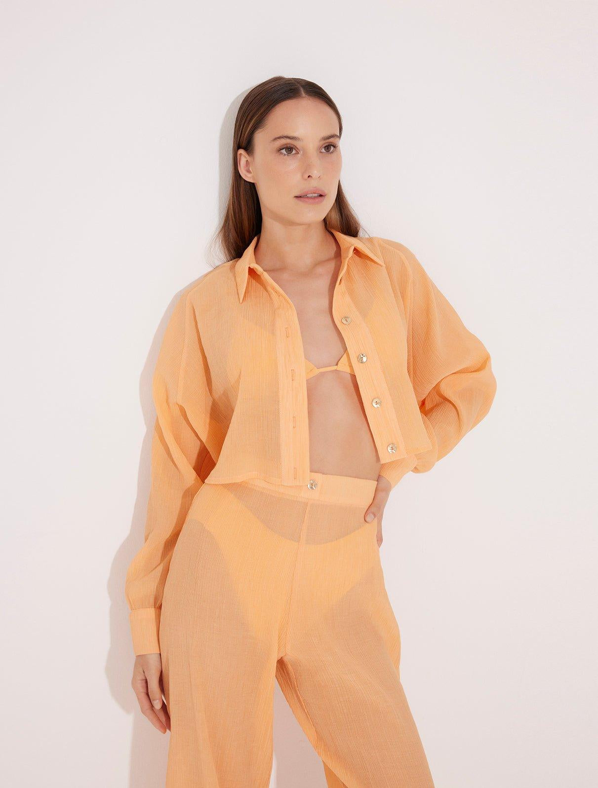 Jacinta Orange Cropped Sheer Long Sleeve Shirt | Moeva | Beachwear Tops | Each week unveils new pieces—luxury swimwear, fluid resort silhouettes, and elevated summer-to-evening essentials designed to carry you from coastal escapes to city nights.
