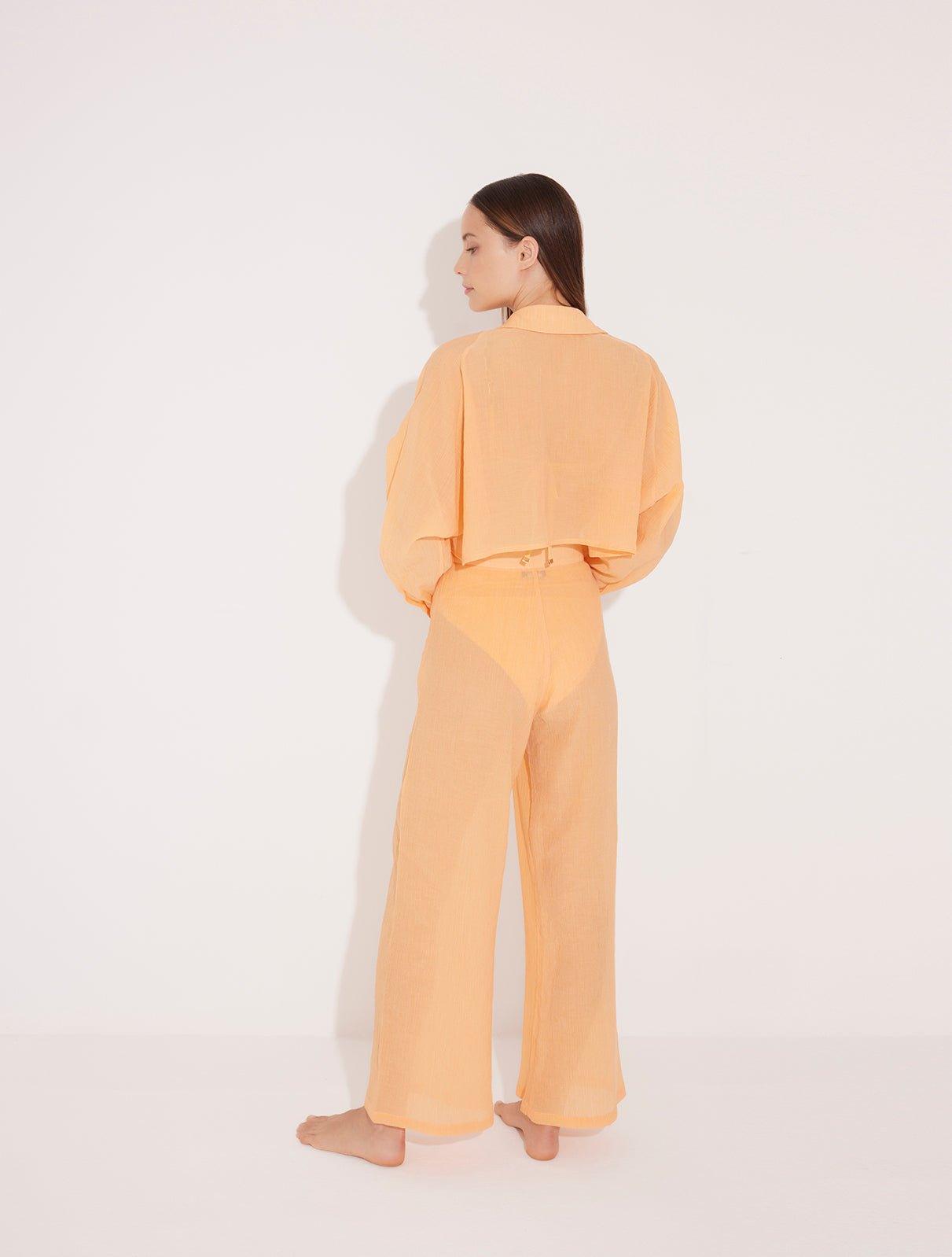 Jacinta Orange Cropped Sheer Long Sleeve Shirt | Moeva | Beachwear Tops | Each week unveils new pieces—luxury swimwear, fluid resort silhouettes, and elevated summer-to-evening essentials designed to carry you from coastal escapes to city nights.
