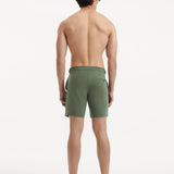 "Back view of Jack army green swim shorts with buttoned pockets and side fasteners"