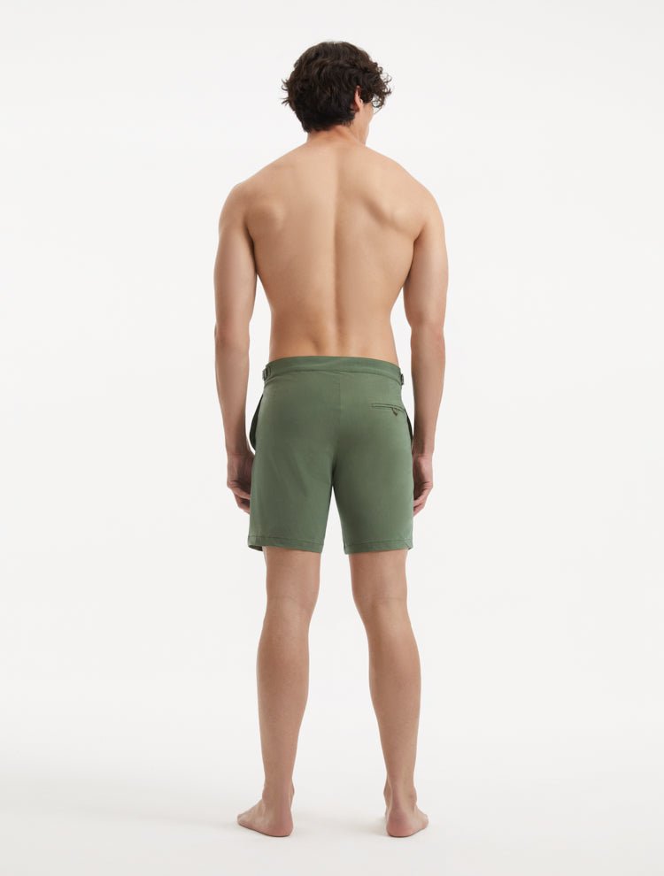 "Back view of Jack army green swim shorts with buttoned pockets and side fasteners"