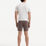 "Back view of Jack brown swim shorts on a model, emphasizing the clean lines and stylish cut"