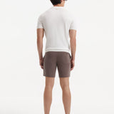 "Back view of Jack brown swim shorts on a model, emphasizing the clean lines and stylish cut"