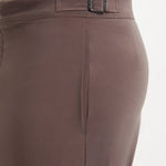 "Close-up of Jack brown swim shorts showing the buttoned back pockets and snap-zip fastening"