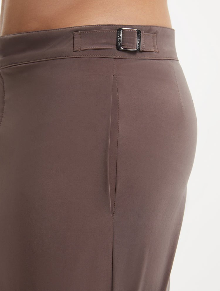 "Close-up of Jack brown swim shorts showing the buttoned back pockets and snap-zip fastening"
