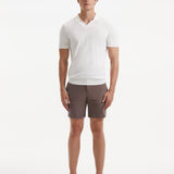 "Front view of a model wearing Jack brown swim shorts, showcasing the modern slim fit and quick-dry fabric"