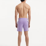 "Back view of Jack lilac swim shorts featuring buttoned back pockets and a slim fit"