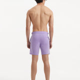 "Back view of Jack lilac swim shorts featuring buttoned back pockets and a slim fit"