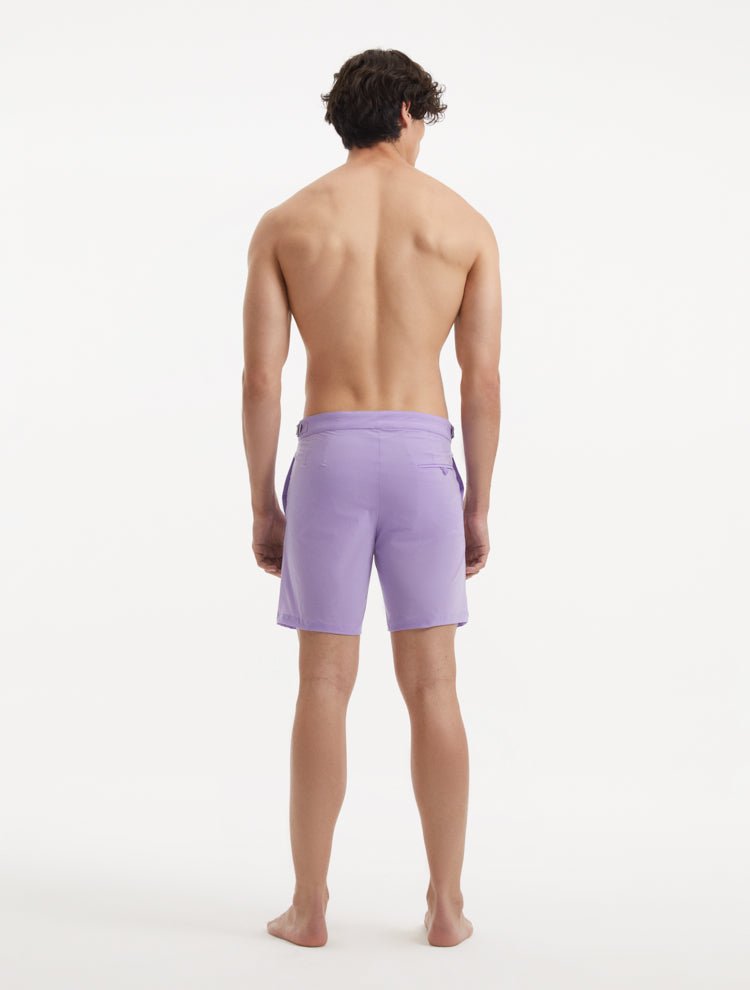 "Back view of Jack lilac swim shorts featuring buttoned back pockets and a slim fit"