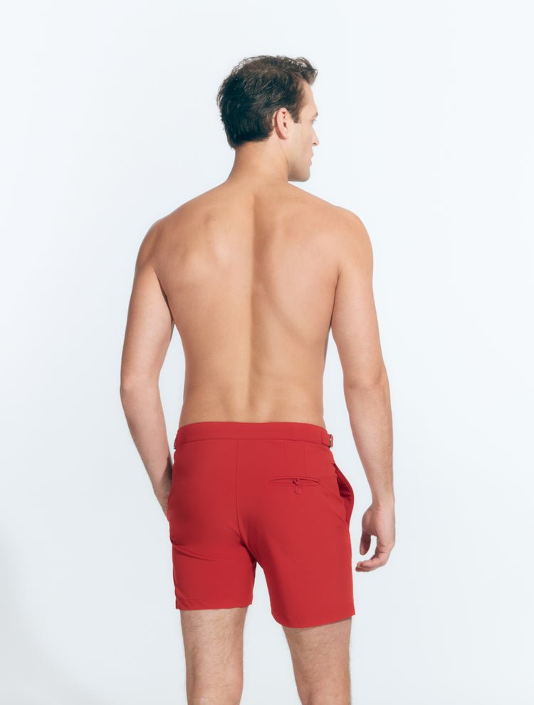 Back View: Model in Jack Red Shorts - MOEVA Luxury Swimwear, Nikel, Mid Length Swim Shorts, Fully Lined, Slim Fit, Strech Classic,  Buttoned Back Pockets, MOEVA Luxury Swimwear
