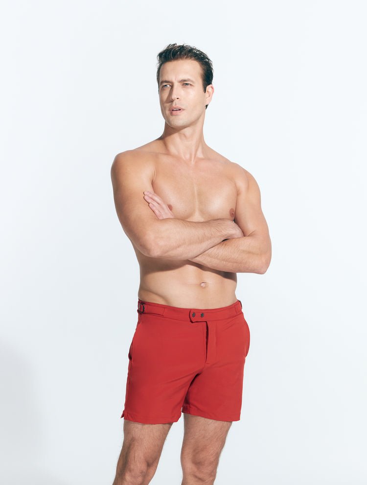 Front View: Model in Jack Red Shorts - MOEVA Luxury Swimwear, Slim Fitting, Lightweight Fabric with Quick Drying, Front Slash Pockets, Snap and Zip Fastening, Buckles at the Waist, Quick Dry, MOEVA Luxury Swimwear