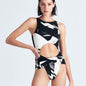 "Model wearing the Jackie Abstract Print Swimsuit from the front, showcasing the high leg cut and twist knot detail."