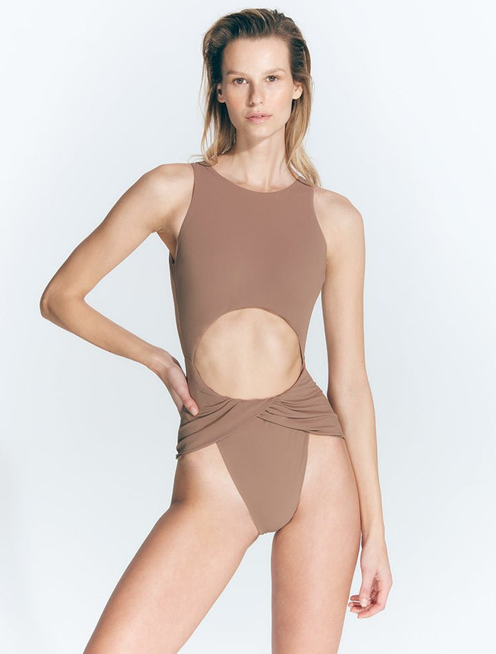 Front View: Model in Jackie Nude Swimsuit - MOEVA Luxury Swimwear, Twist-Front Detail, High Neckline, High Neck One Piece Swimsuit, Back Clasp Closure, Low Back, Moderate Coverage Bottom, Italian Fabric, Special Lucra Xtralife Certificate, MOEVA Luxury Swimwear